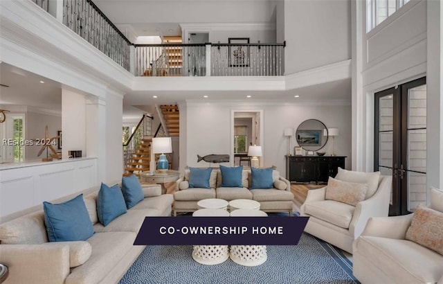 living room with ornamental molding and a high ceiling