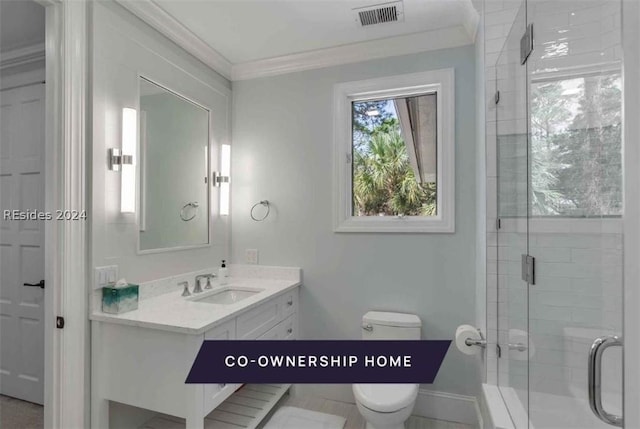 bathroom featuring vanity, crown molding, toilet, and walk in shower