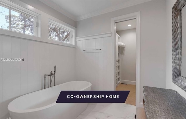 bathroom with ornamental molding and a tub