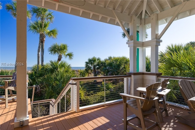 wooden terrace featuring a gazebo and a water view