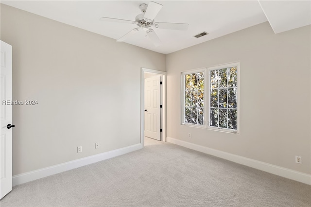 empty room with ceiling fan and light colored carpet