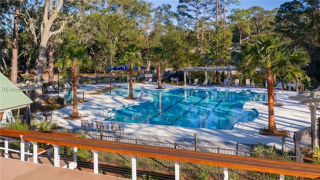 view of swimming pool featuring a pergola and a patio area