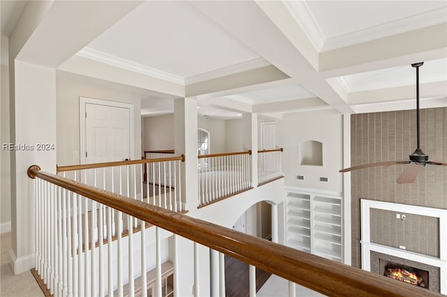 hallway featuring beamed ceiling, ornamental molding, and coffered ceiling