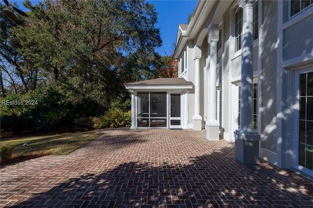 view of patio featuring a sunroom