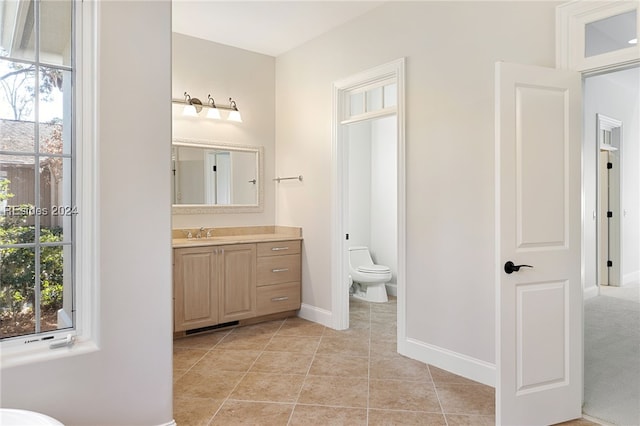 bathroom with vanity, tile patterned floors, and toilet