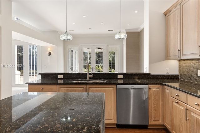 kitchen with pendant lighting, dishwasher, light brown cabinets, and dark stone countertops