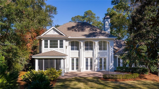 rear view of property featuring french doors and a yard