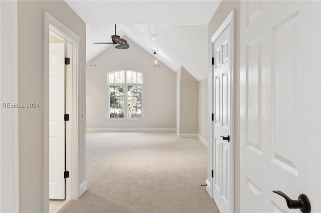 corridor with light carpet and lofted ceiling