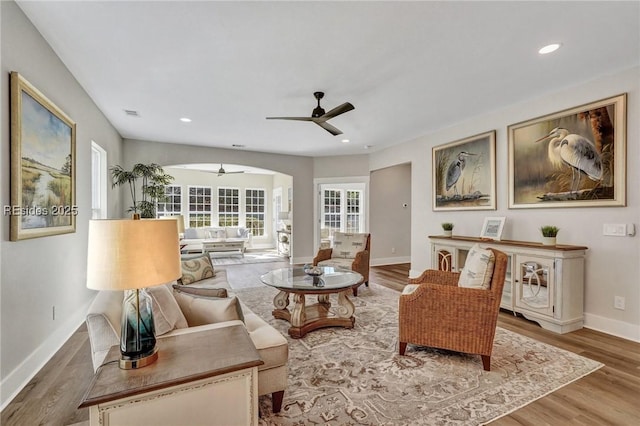 sitting room with hardwood / wood-style flooring and ceiling fan