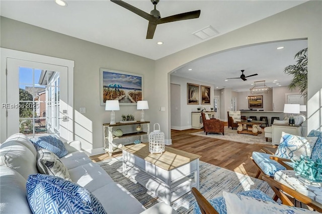 living room with ceiling fan and light hardwood / wood-style floors