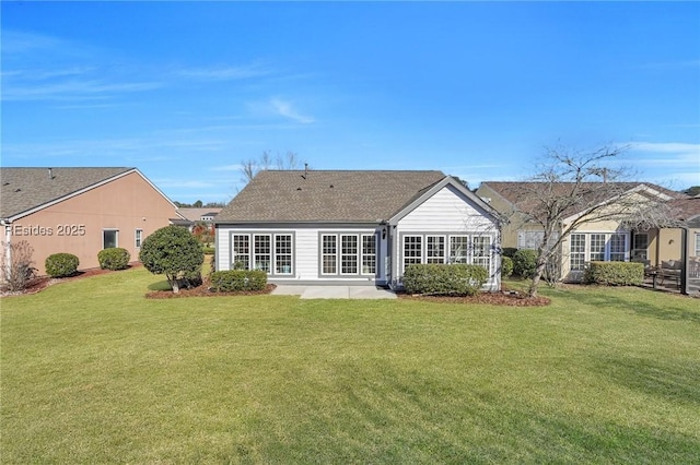 back of property with a yard and a patio area