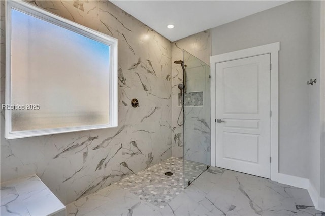 bathroom with plenty of natural light and tiled shower