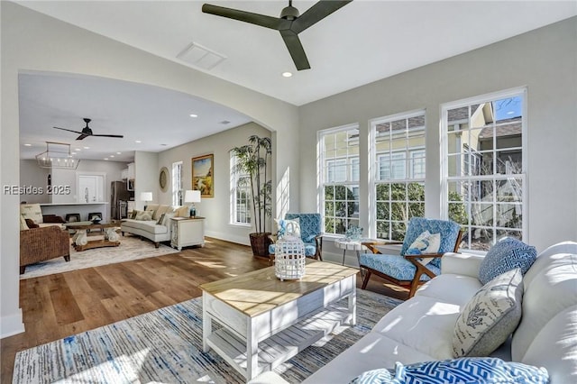 living room with hardwood / wood-style flooring and ceiling fan