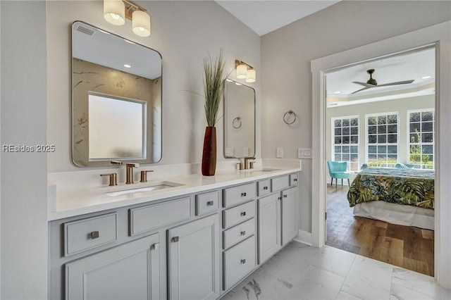 bathroom with ceiling fan and vanity