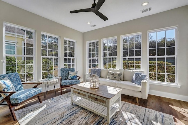 sunroom / solarium featuring ceiling fan