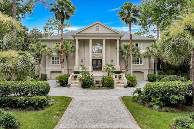 neoclassical home featuring a garage