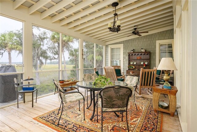 sunroom / solarium featuring lofted ceiling and ceiling fan