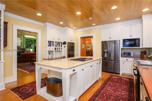 kitchen featuring wood counters, white cabinetry, black appliances, wooden ceiling, and light hardwood / wood-style flooring