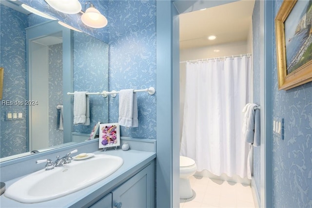 bathroom with tile patterned flooring, vanity, walk in shower, and toilet