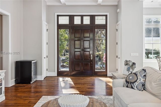 entryway featuring coffered ceiling, beam ceiling, and dark wood-type flooring