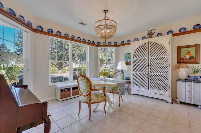 tiled dining space with an inviting chandelier