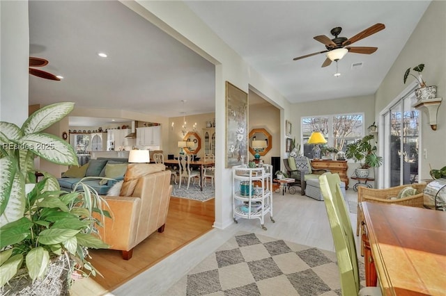 living room featuring ceiling fan and light wood-type flooring