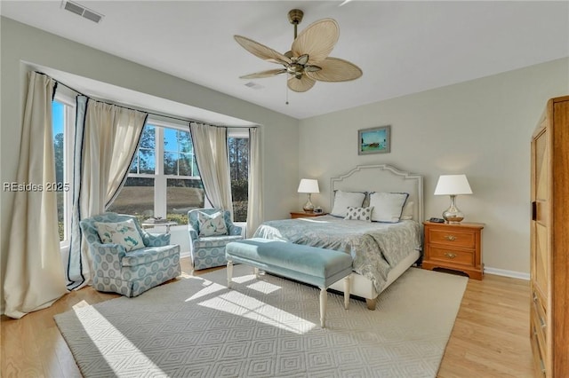 bedroom with multiple windows, light hardwood / wood-style flooring, and ceiling fan