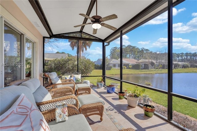 unfurnished sunroom with vaulted ceiling, a water view, and ceiling fan