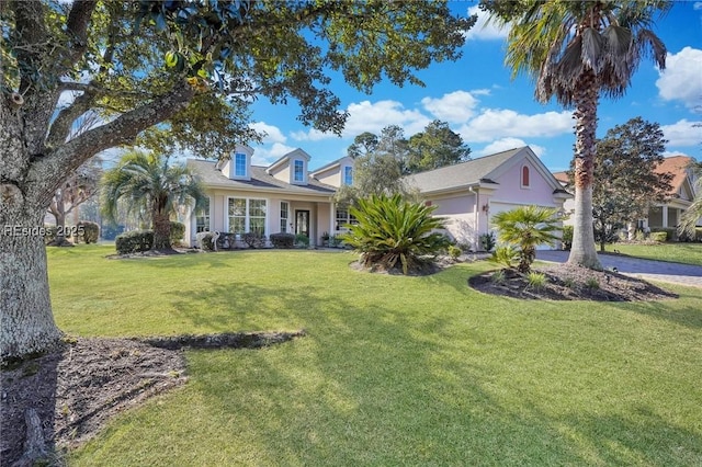 view of front of house with a garage and a front yard