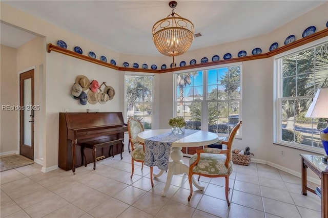 tiled dining space with a notable chandelier