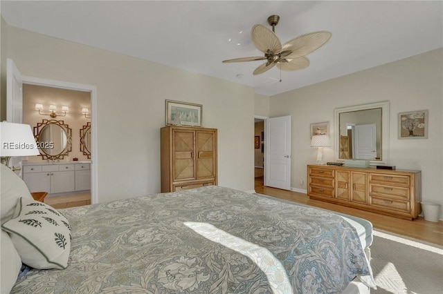 bedroom featuring connected bathroom, light hardwood / wood-style flooring, and ceiling fan