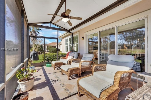 sunroom / solarium featuring ceiling fan, lofted ceiling, and a wealth of natural light