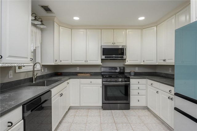 kitchen with white cabinetry, stainless steel appliances, sink, and light tile patterned floors