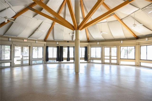 interior space featuring lofted ceiling with beams, plenty of natural light, and ceiling fan