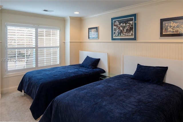 bedroom with ornamental molding and carpet floors