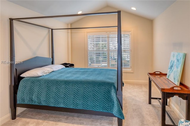 bedroom with vaulted ceiling and light colored carpet