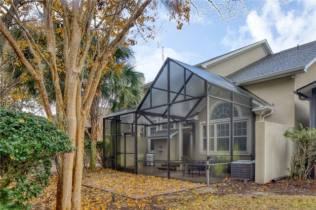 back of house with cooling unit and a patio