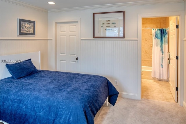 carpeted bedroom featuring connected bathroom and ornamental molding