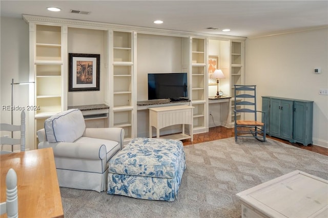 living room featuring crown molding and hardwood / wood-style flooring