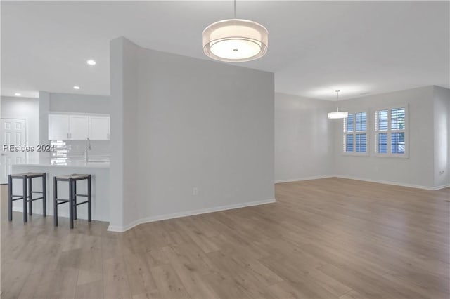 interior space featuring sink and light wood-type flooring