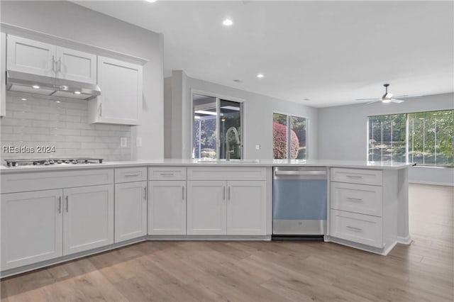 kitchen with sink, dishwasher, white cabinetry, tasteful backsplash, and gas stovetop