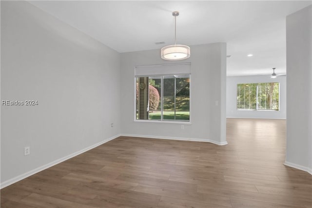 unfurnished dining area with hardwood / wood-style flooring and ceiling fan