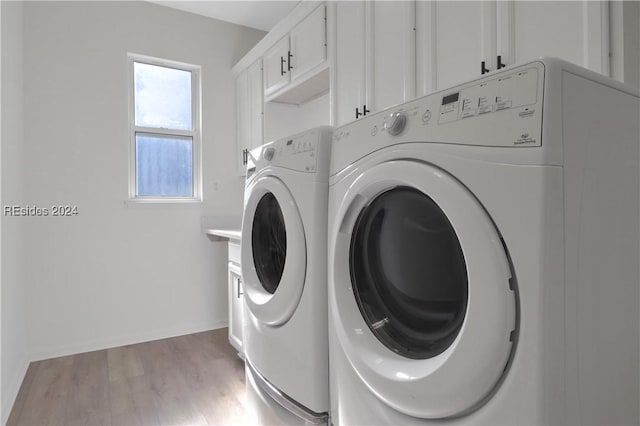 laundry room with cabinets, wood-type flooring, and independent washer and dryer