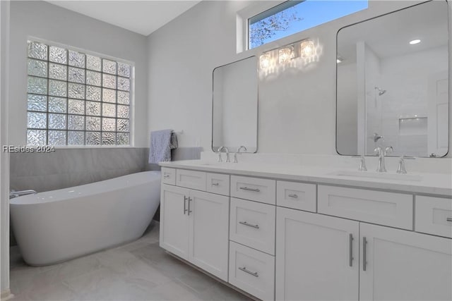 bathroom featuring vanity, tile walls, and a tub