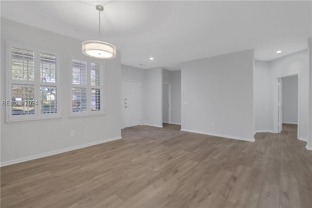 unfurnished room with light wood-type flooring