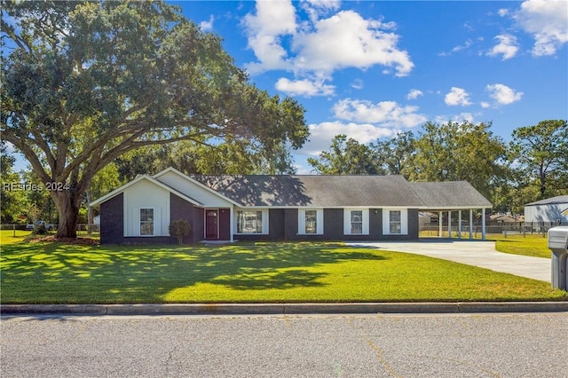 ranch-style house with a carport and a front lawn