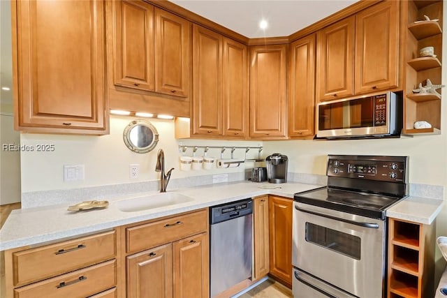 kitchen featuring appliances with stainless steel finishes, light stone countertops, and sink