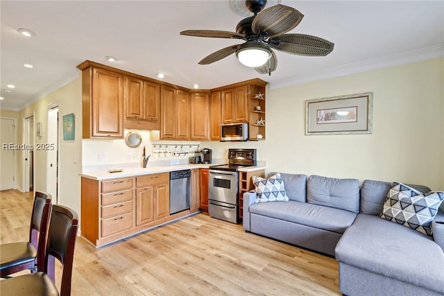 kitchen with appliances with stainless steel finishes, sink, ceiling fan, crown molding, and light wood-type flooring