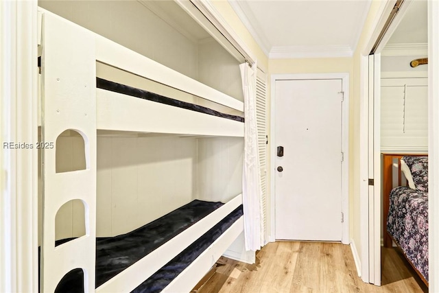 bedroom featuring crown molding and light hardwood / wood-style flooring