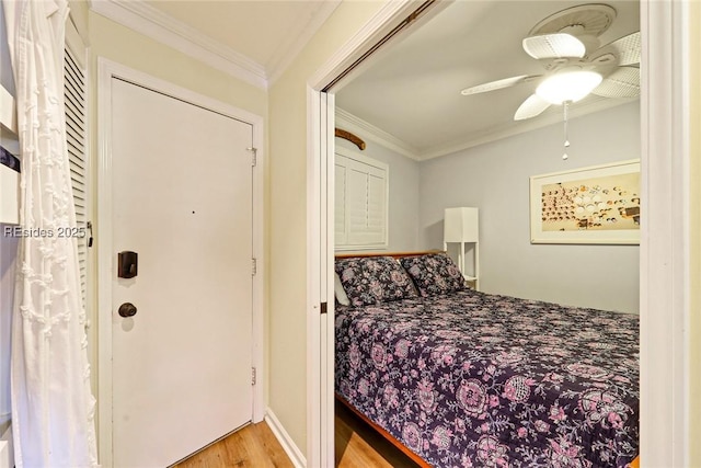 bedroom with crown molding, ceiling fan, and light hardwood / wood-style floors